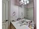 Pretty pink bathroom with a single sink vanity, ample counter space, and neutral accents at 2996 Walkin Horse Trl, Buford, GA 30519