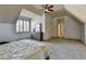 Bedroom featuring light gray carpet, a ceiling fan, and an open hallway at 2996 Walkin Horse Trl, Buford, GA 30519