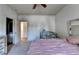 Bedroom view featuring a mirrored bed, crib, and adjacent bathroom entrance at 2996 Walkin Horse Trl, Buford, GA 30519