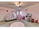 Pink-themed bedroom featuring a princess carriage bed and whimsical decor at 2996 Walkin Horse Trl, Buford, GA 30519