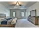Spacious bedroom with a ceiling fan, natural light, and light gray carpet at 2996 Walkin Horse Trl, Buford, GA 30519
