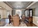 Formal dining room featuring dark wood floors, ornate chandelier, and elegant furnishings at 2996 Walkin Horse Trl, Buford, GA 30519