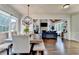 Open dining area with wood table and bench seating, seamlessly connected to the living area at 2996 Walkin Horse Trl, Buford, GA 30519