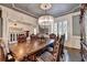 Spacious dining area with a large table, decorative chandelier, and classic trim details at 2996 Walkin Horse Trl, Buford, GA 30519