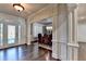 Bright foyer with decorative glass front door and hardwood floors leading to the dining room at 2996 Walkin Horse Trl, Buford, GA 30519