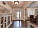 Elegant foyer with hardwood floors, decorative mirror, and detailed trim work at 2996 Walkin Horse Trl, Buford, GA 30519