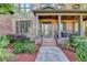 Charming front porch with brick columns, elegant door, and a cozy seating area at 2996 Walkin Horse Trl, Buford, GA 30519