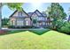 Lovely two-story home featuring a well-maintained lawn, stone accents, and lush landscaping at 2996 Walkin Horse Trl, Buford, GA 30519