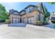 Spacious three-car garage with a wide driveway and well-kept landscaping around the perimeter at 2996 Walkin Horse Trl, Buford, GA 30519