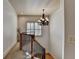 A hallway with a chandelier and iron railing at 2996 Walkin Horse Trl, Buford, GA 30519