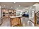 Open kitchen with an island, stainless steel appliances, custom cabinets, and hardwood flooring at 2996 Walkin Horse Trl, Buford, GA 30519