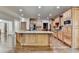 Well-equipped kitchen with a central island, wooden cabinets, and stainless steel appliances at 2996 Walkin Horse Trl, Buford, GA 30519