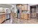 Gourmet kitchen with stainless steel appliances, wood cabinets, and granite countertops at 2996 Walkin Horse Trl, Buford, GA 30519