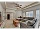 Bright living room featuring tray ceilings, plantation shutters, and a comfortable sectional sofa at 2996 Walkin Horse Trl, Buford, GA 30519