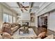 Bright living room with coffered ceilings, fireplace, built-in shelving, and comfortable seating at 2996 Walkin Horse Trl, Buford, GA 30519