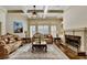 Elegant living room with coffered ceilings, fireplace, and large windows that brighten the space at 2996 Walkin Horse Trl, Buford, GA 30519
