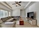 Open living room with a comfortable couch and a large television at 2996 Walkin Horse Trl, Buford, GA 30519