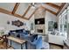 Cozy living room featuring a stone fireplace, vaulted ceilings, and comfortable blue sofas at 2996 Walkin Horse Trl, Buford, GA 30519