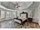 Luxurious main bedroom features tray ceilings, herringbone floors, and natural light at 2996 Walkin Horse Trl, Buford, GA 30519