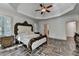 A luxurious main bedroom with hardwood floors, tray ceilings, and natural light at 2996 Walkin Horse Trl, Buford, GA 30519