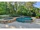 Beautiful backyard pool and spa are surrounded by mature trees and lush landscaping at 2996 Walkin Horse Trl, Buford, GA 30519