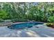 Inviting pool with stone-look coping surrounded by lush landscaping offers a private backyard oasis at 2996 Walkin Horse Trl, Buford, GA 30519
