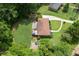 Aerial view showcasing a charming home with a well-kept yard, patio with umbrella, and verdant surrounding trees at 388 Talcott Nw Cir, Marietta, GA 30064