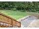 Backyard featuring a spacious lawn, stone landscaping, and wooden stairs leading to a patio at 388 Talcott Nw Cir, Marietta, GA 30064