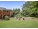 Landscaped backyard featuring a large lawn, garden area, and wooden deck at 388 Talcott Nw Cir, Marietta, GA 30064