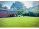 Expansive green backyard featuring a wooden deck, lush lawn, mature trees, and well-maintained landscaping at 388 Talcott Nw Cir, Marietta, GA 30064