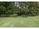 Lush backyard featuring a well-maintained lawn, mature trees, and a landscaped border at 388 Talcott Nw Cir, Marietta, GA 30064