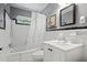 Bright bathroom featuring a shower-tub combo, white tile, and black accents at 388 Talcott Nw Cir, Marietta, GA 30064