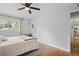 Cozy bedroom featuring ceiling fan, hardwood floors, and a view of nature at 388 Talcott Nw Cir, Marietta, GA 30064