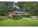 A classic brick home set on a lush green lot with mature trees and manicured landscaping at 388 Talcott Nw Cir, Marietta, GA 30064