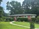 Traditional brick home featuring a well-kept lawn and manicured landscaping at 388 Talcott Nw Cir, Marietta, GA 30064