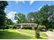 Charming one-story brick home with a well-manicured front lawn, a curved walkway, and mature landscaping at 388 Talcott Nw Cir, Marietta, GA 30064