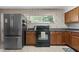 Charming kitchen with stainless steel refrigerator, black range and granite countertops at 388 Talcott Nw Cir, Marietta, GA 30064