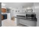 The kitchen features a peninsula with granite countertop, microwave, and tile floor at 388 Talcott Nw Cir, Marietta, GA 30064