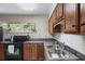 Well-maintained kitchen featuring dark countertops, tile backsplash, stainless sink, and updated appliances at 388 Talcott Nw Cir, Marietta, GA 30064