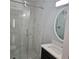 The bathroom has a glass shower, modern vanity, and marble-like tiling at 487 Eastside Dr, Dacula, GA 30019
