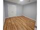 This bedroom features hardwood floors, neutral walls, and a double-door closet at 487 Eastside Dr, Dacula, GA 30019