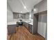 This kitchen has gray cabinets, stainless appliances and quartz countertops for modern living at 487 Eastside Dr, Dacula, GA 30019