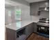 Well-appointed kitchen with gray island, quartz countertops, and stainless steel appliances, perfect for cooking at 487 Eastside Dr, Dacula, GA 30019