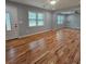 Bright living room features gleaming hardwood floors and ample natural light, perfect for gatherings at 487 Eastside Dr, Dacula, GA 30019