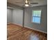 This living room has hardwood floors, new paint, and lots of natural light at 487 Eastside Dr, Dacula, GA 30019
