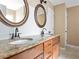 Elegant bathroom with double sinks, granite counters, and framed mirrors, offering a luxurious feel at 1615 Nw Vinebrook Nw Ter, Kennesaw, GA 30144