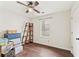 Bright bedroom features hardwood floors, a ceiling fan, and natural light, offering a cozy retreat at 1615 Nw Vinebrook Nw Ter, Kennesaw, GA 30144