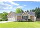 Charming single-story home with a well-manicured lawn and a lovely flower bed in the front yard at 1615 Nw Vinebrook Nw Ter, Kennesaw, GA 30144