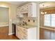 Compact kitchen featuring granite countertops, tiled backsplash, and wooden floors at 1615 Nw Vinebrook Nw Ter, Kennesaw, GA 30144