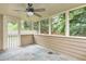 Enclosed porch with a ceiling fan and a view of the backyard, ideal for relaxation and outdoor enjoyment at 1615 Nw Vinebrook Nw Ter, Kennesaw, GA 30144